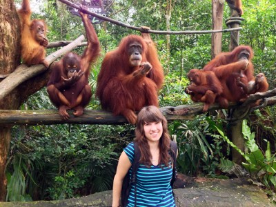 Natasha Korva surrounded by monkeys in Singapore