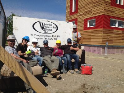solar house team with construction workers