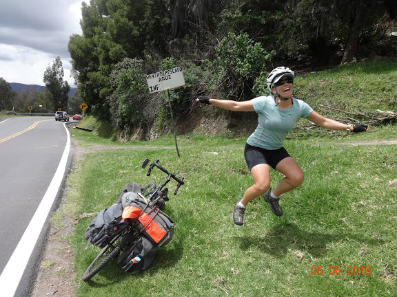 Jumping by her bicycle