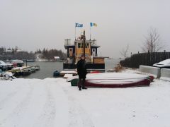 Vincent standing by a boat in Yellowknife