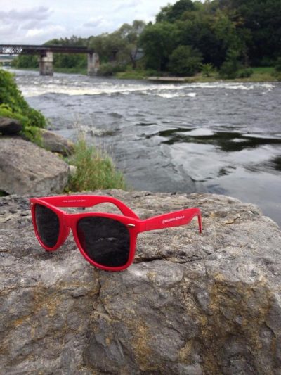 red Orientation sunglasses lying on rock