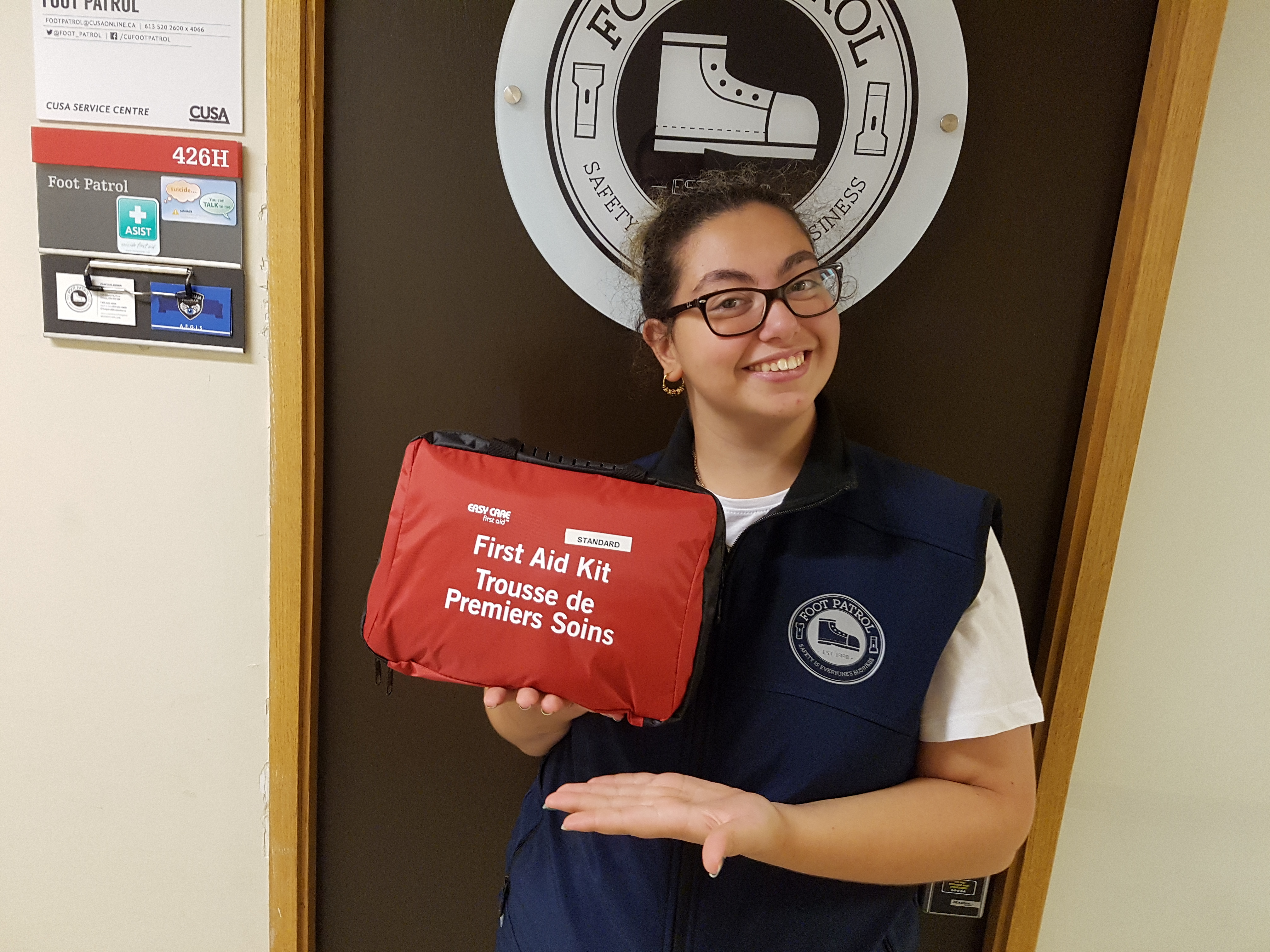 student holding a first aid kit